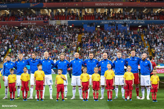 Iceland national football team lined up on field at 2018 FIFA World Cup in Russia, with children
