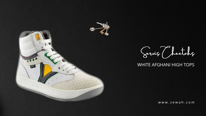 White Afghani high top sneaker with green and yellow details on a black background
