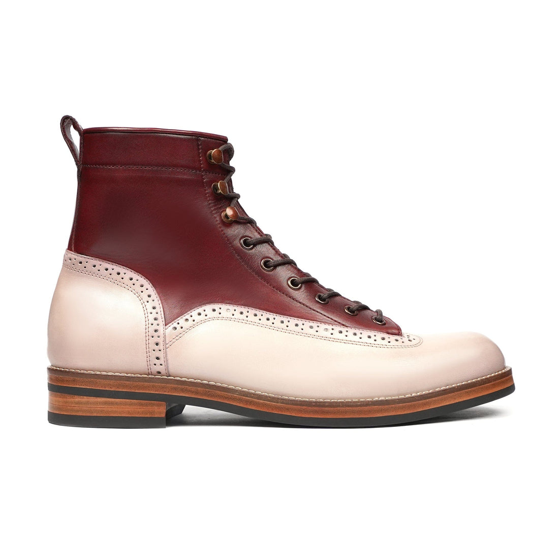 Two-tone leather lace-up boot with brogue detailing and wooden heel on white background
