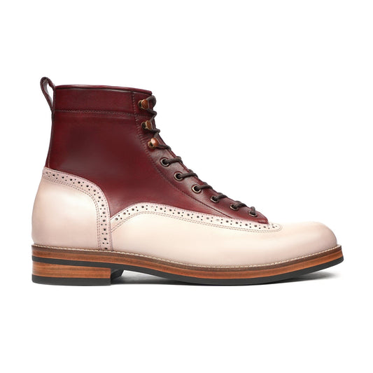 Two-tone leather lace-up boot with brogue detailing and wooden heel on white background