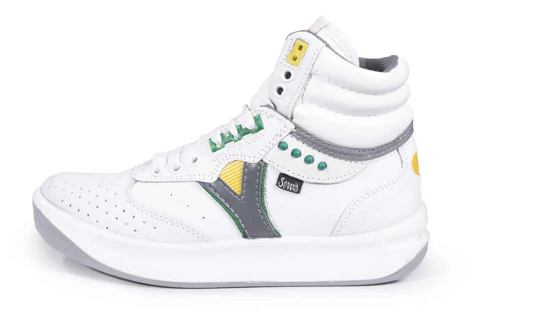 White high-top sneaker with green, yellow, and gray accents, side view on white background