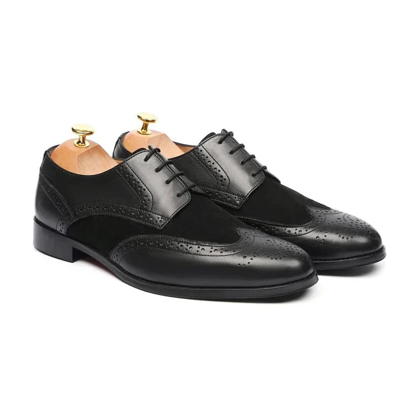 Black leather dress shoes with brogue detailing and lace-up design on white background