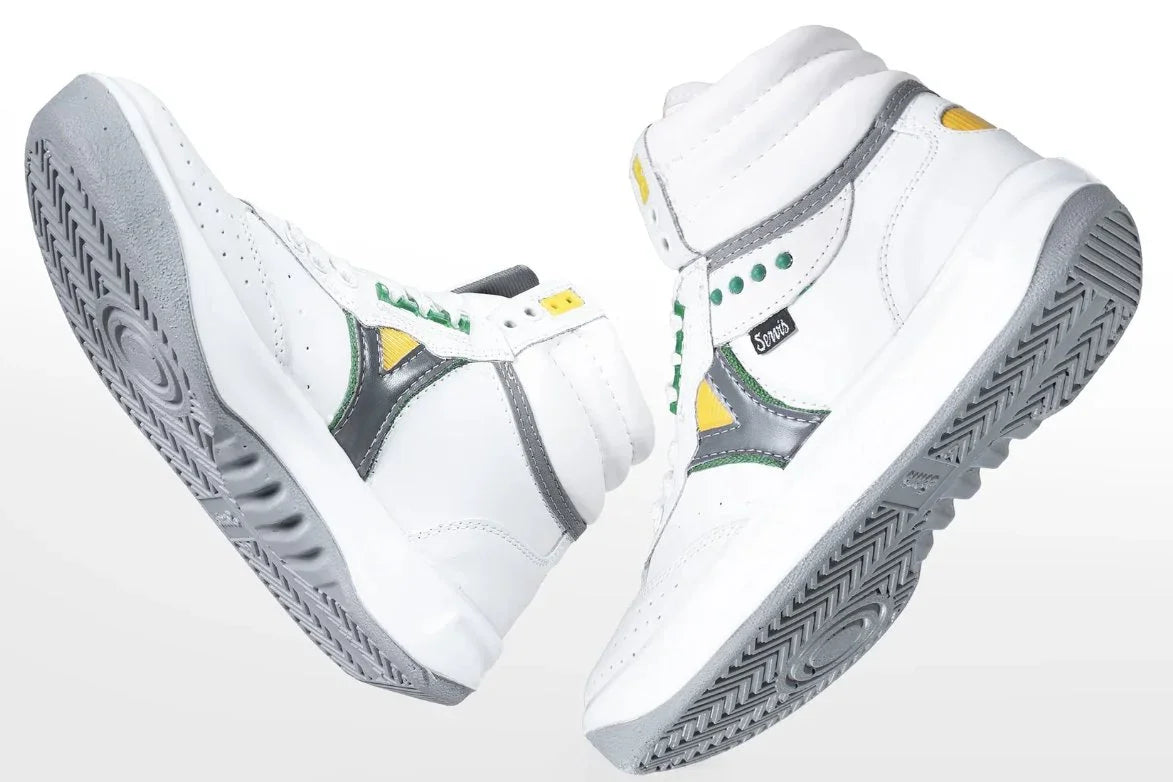 White high-top athletic sneakers with gray soles, yellow and green accents, and side logo tag