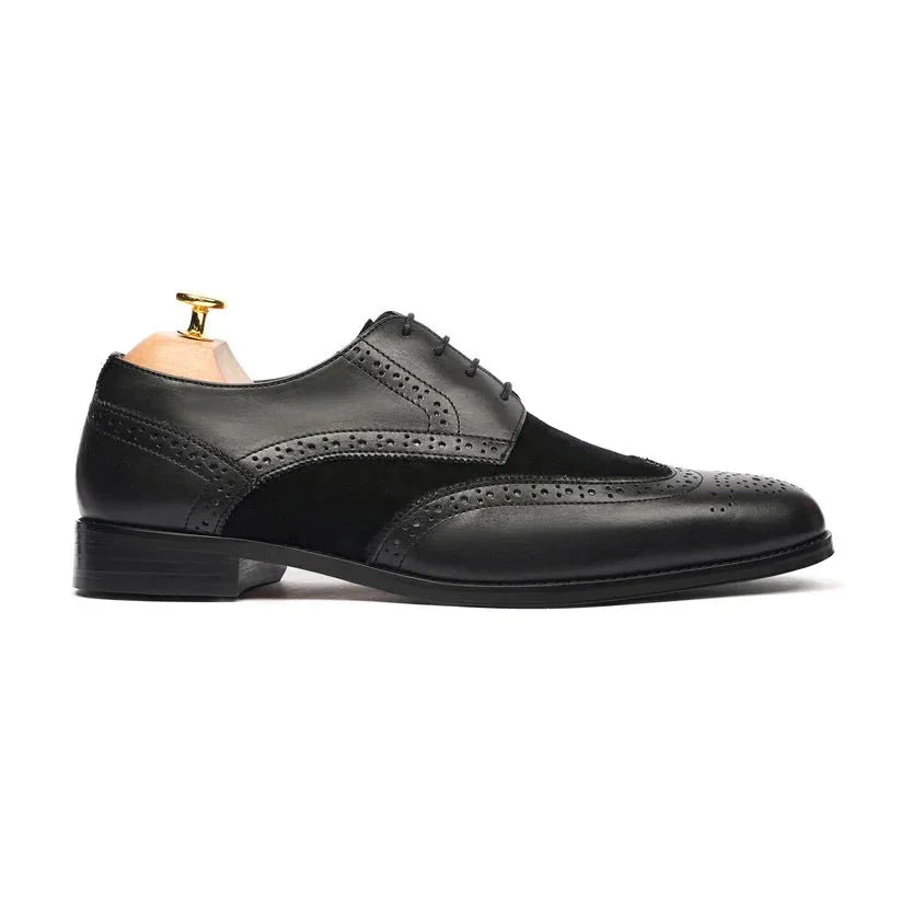Black leather and suede wingtip Oxford dress shoe with brogue detailing, side view